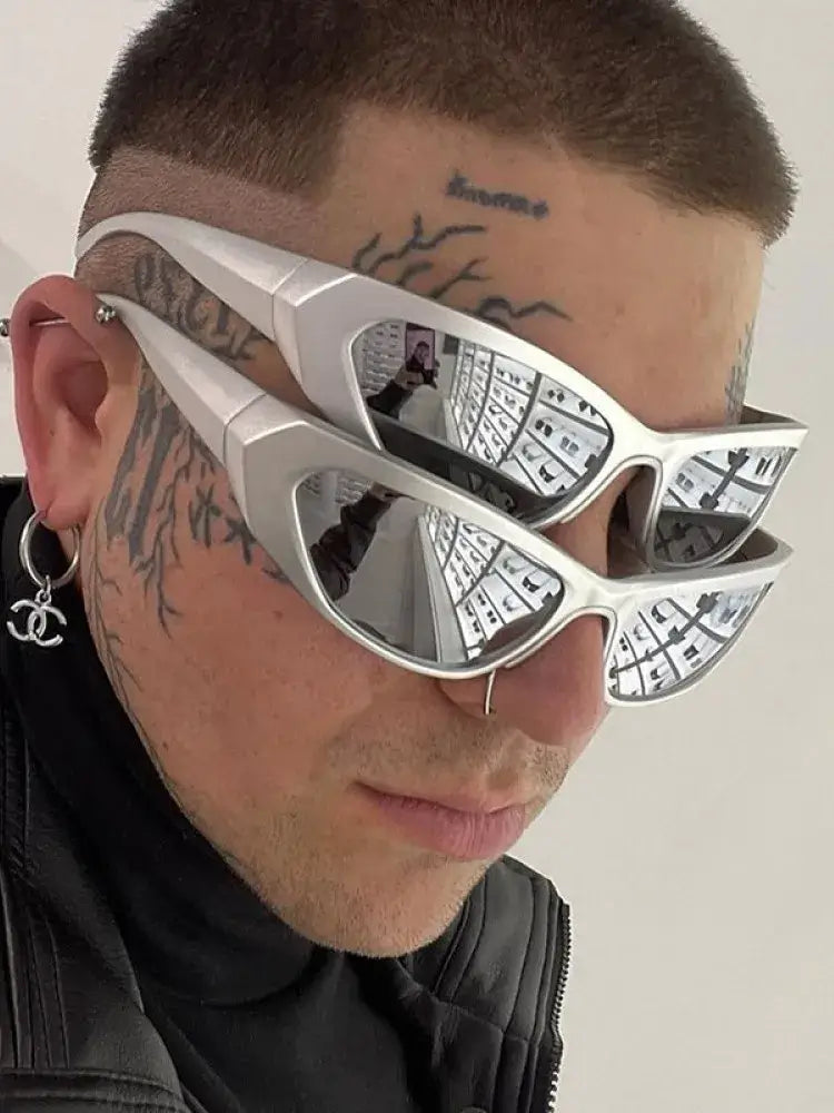 Person wearing futuristic steampunk cyberpunk sunglasses with mirror lenses and sleek alloy frame.