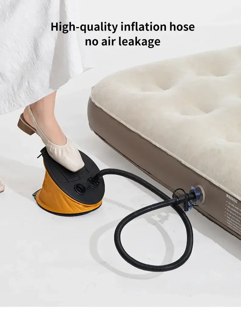 Portable foot pump inflating an air mattress, featuring high-quality hose and no air leakage design for camping and travel.