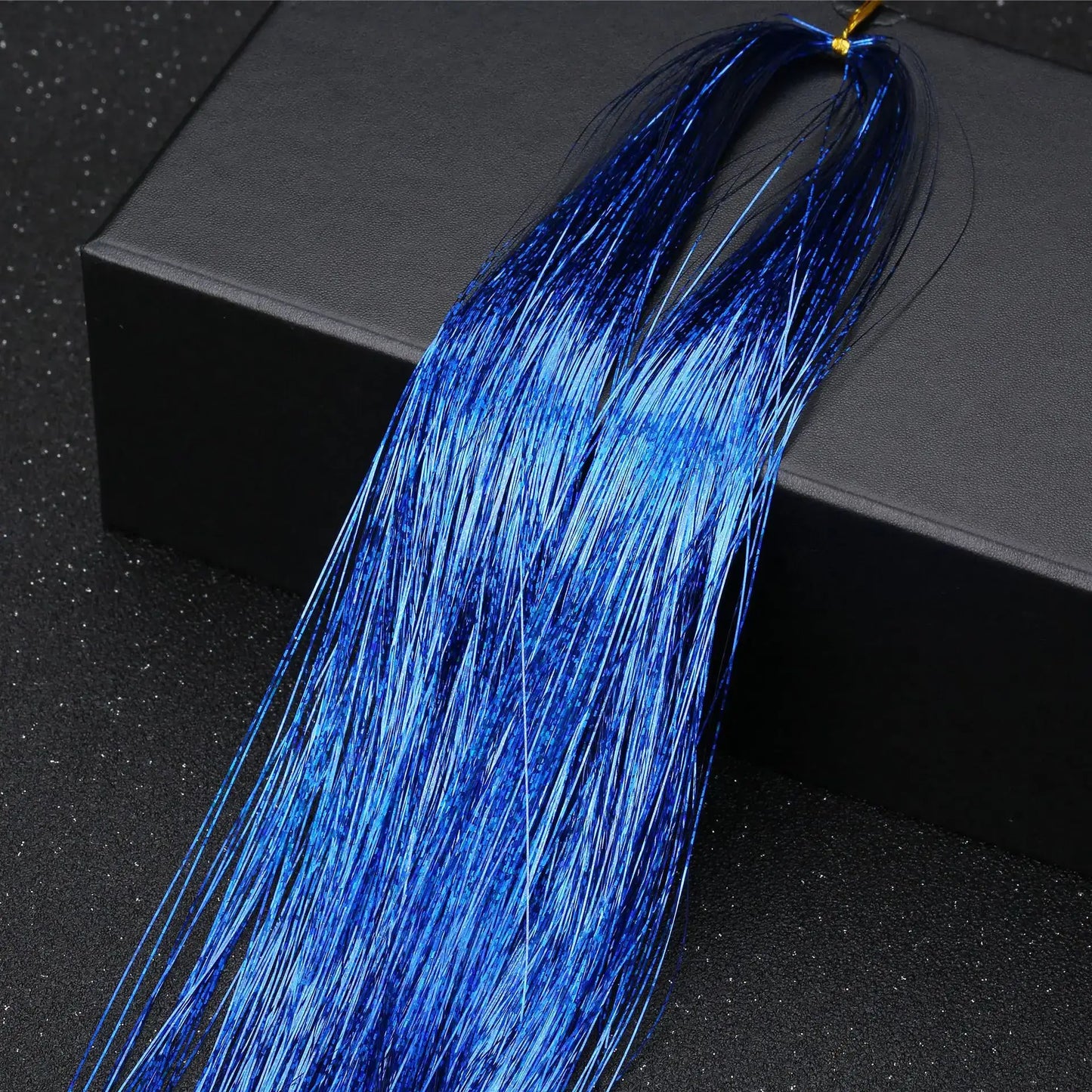 Vibrant blue hair tinsel extension from Rainbow Glitter Hair Tinsel Kit, ideal for styling at parties and festivals.