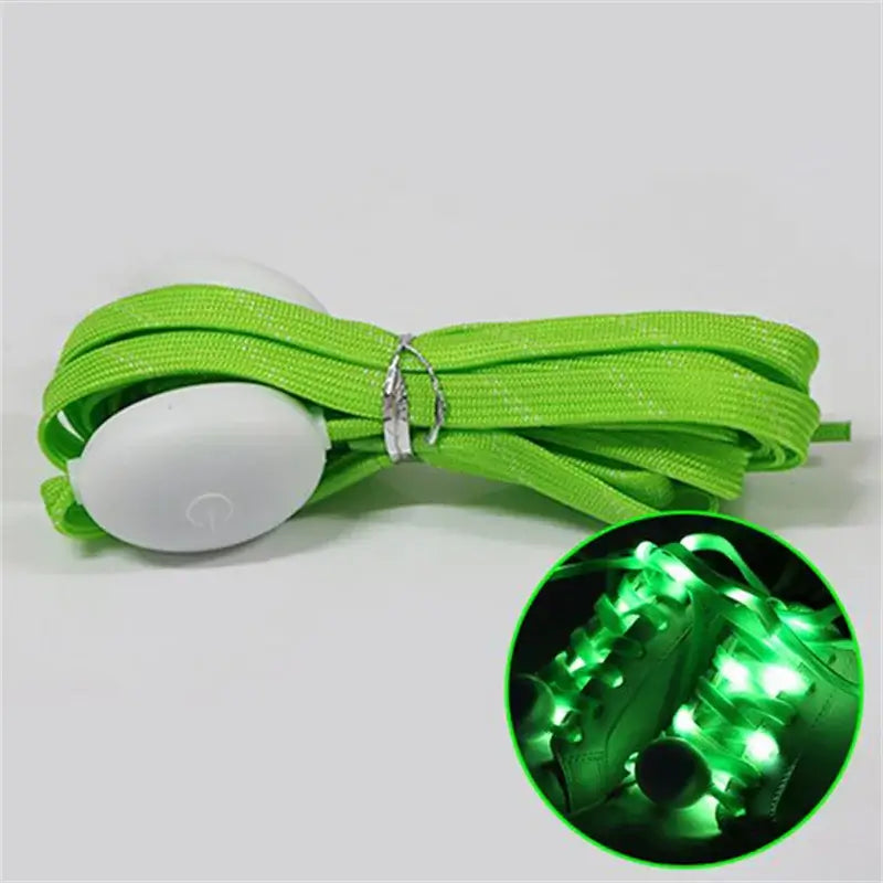 Green LED light-up shoelaces with glowing effect for sneakers in dark setting, showcasing vibrant illumination and universal fit.