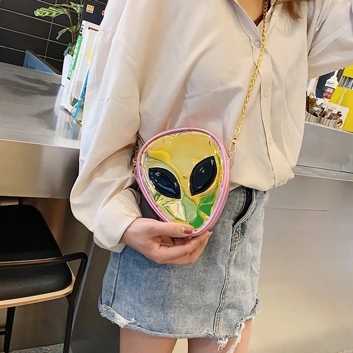 Trendy alien head transparent jelly shoulder bag with gold chain, perfect for festivals and parties.