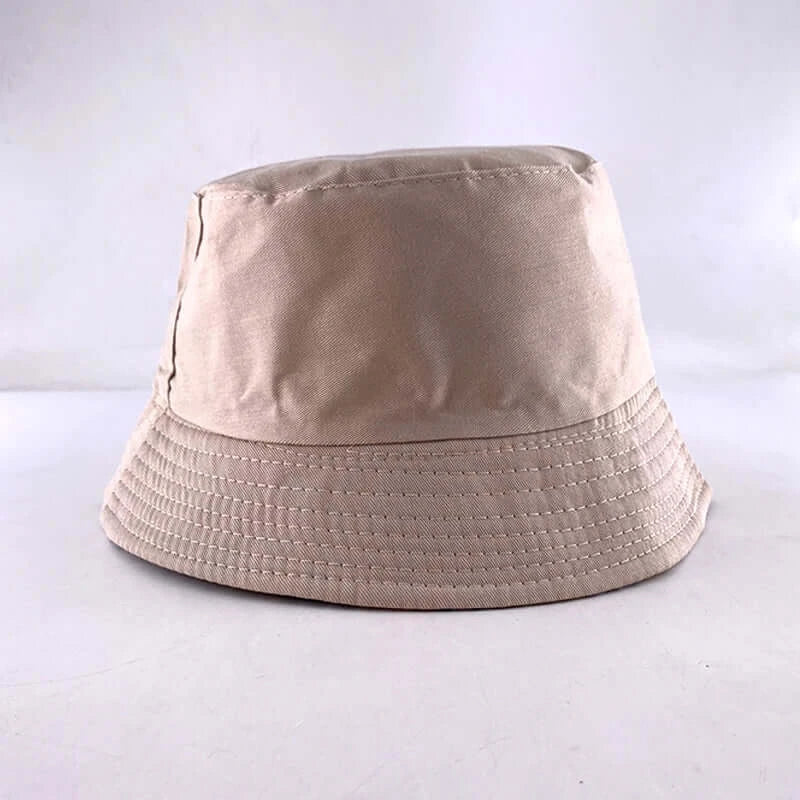 Beige bucket hat with stitched brim, showcasing a simple and classic design against a plain background.