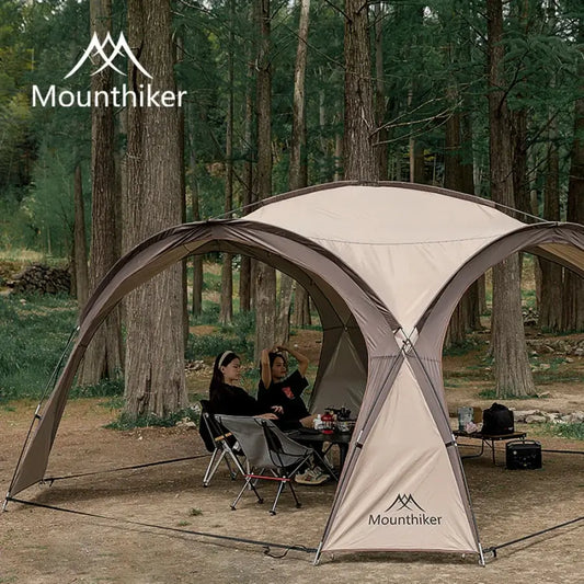 Spacious dome tent with people enjoying outdoor camping under trees, featuring durable design and portability.