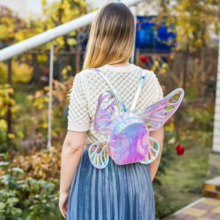 Woman wearing holographic butterfly wings mini backpack, ideal for festivals and parties.