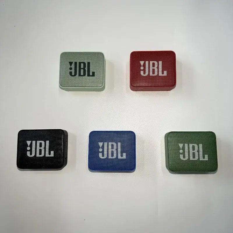 Assorted colors of JBL GO 2 Bluetooth speakers showcasing compact, wireless, waterproof designs.