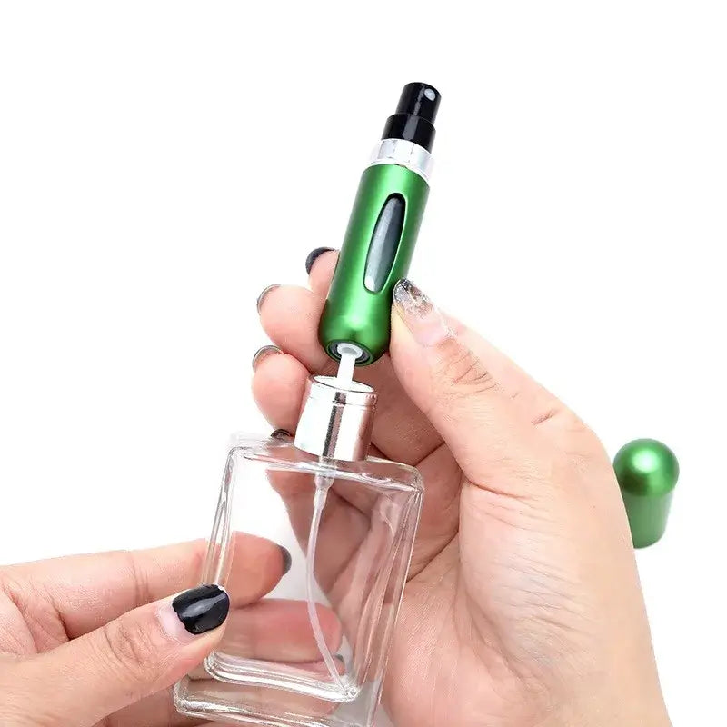 Green portable refillable perfume atomizer being filled from a bottle, ideal for travel with 5ml and 8ml size options.