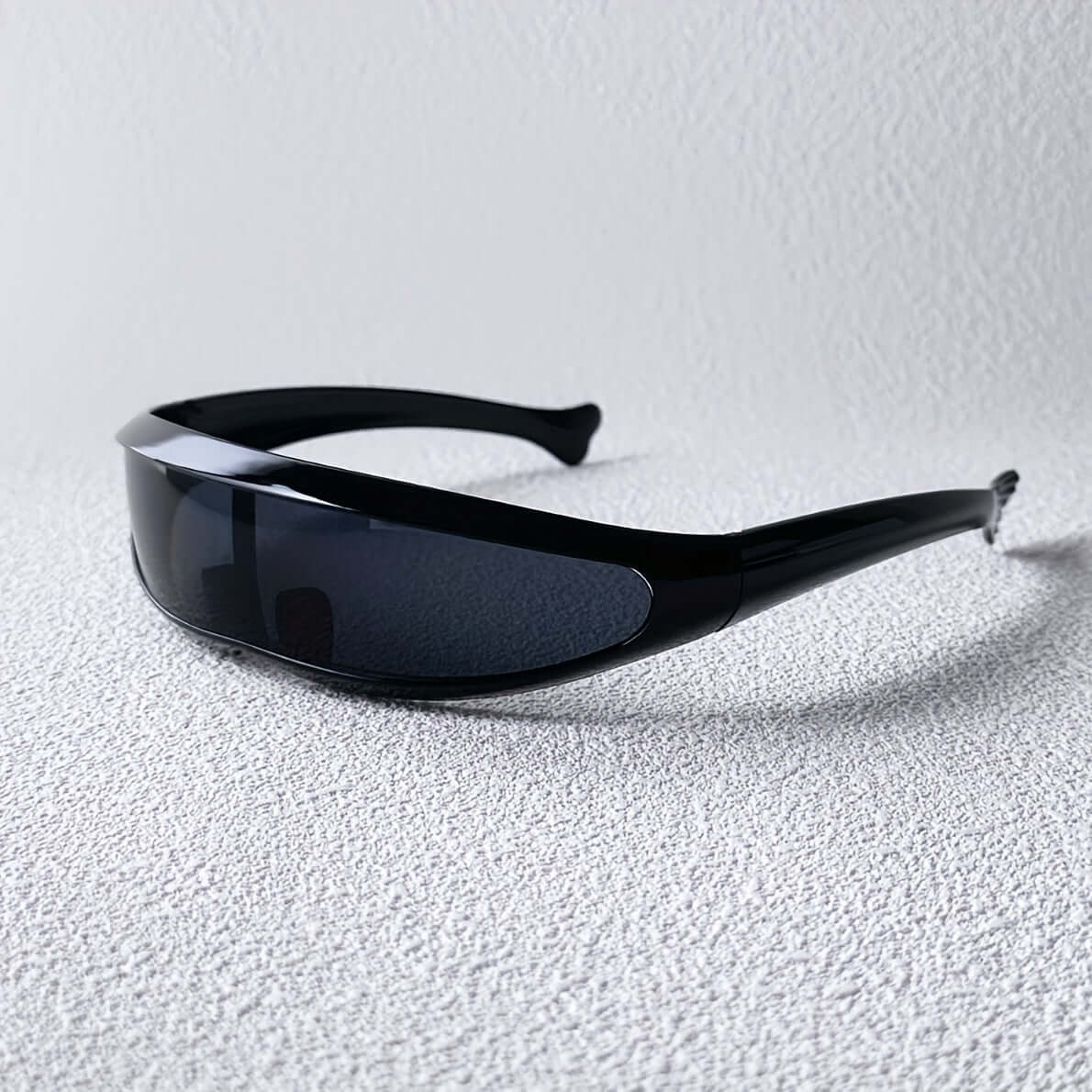 Futuristic fish-shaped sunglasses with sleek black design, featuring anti-reflective lenses for outdoor sports and hiking adventures.