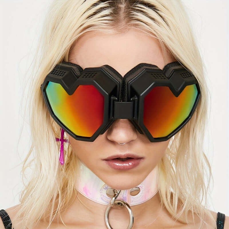 Oversized heart-shaped Y2K fashion glasses with mirrored lenses in a rainbow hue, ideal for rave and festival wear.