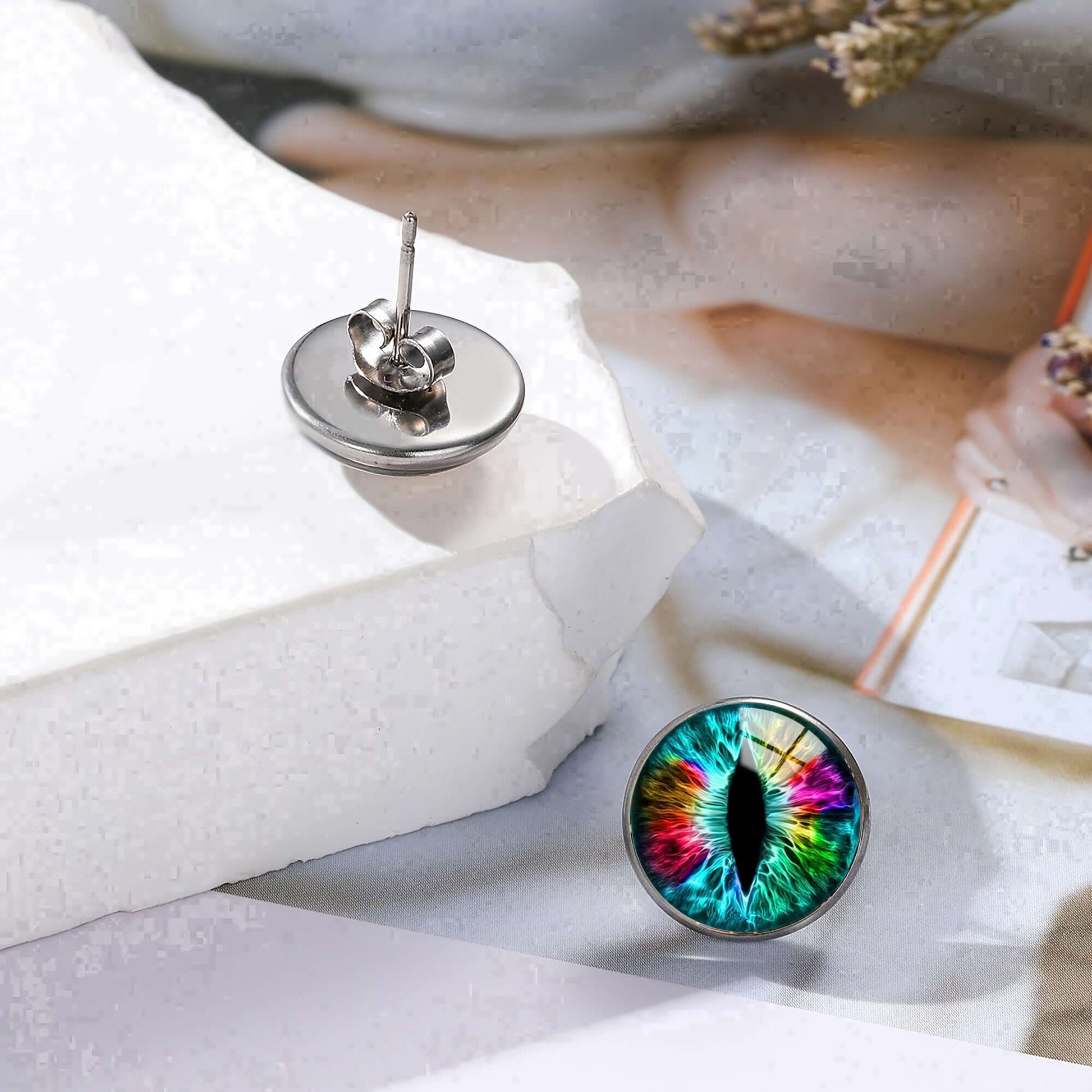 Colorful dragon eye stainless steel stud earrings in gothic style with vibrant design on white background.