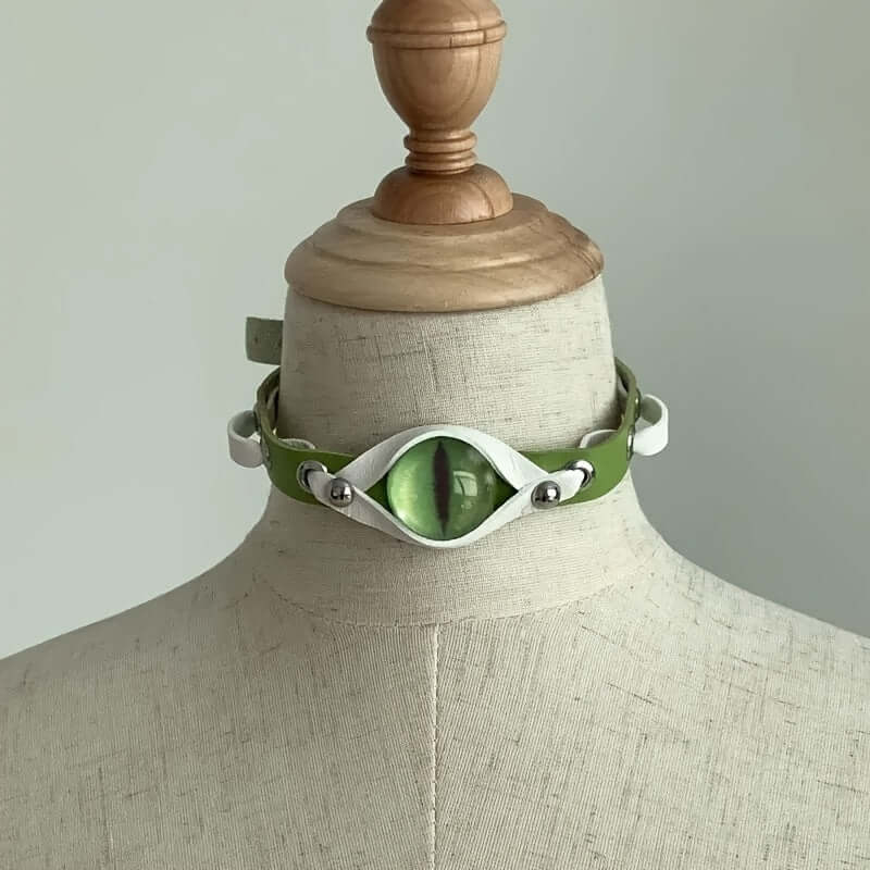 Y2K eye-shaped choker necklace with green PU leather and silver accents on a mannequin, trendy unisex punk style.