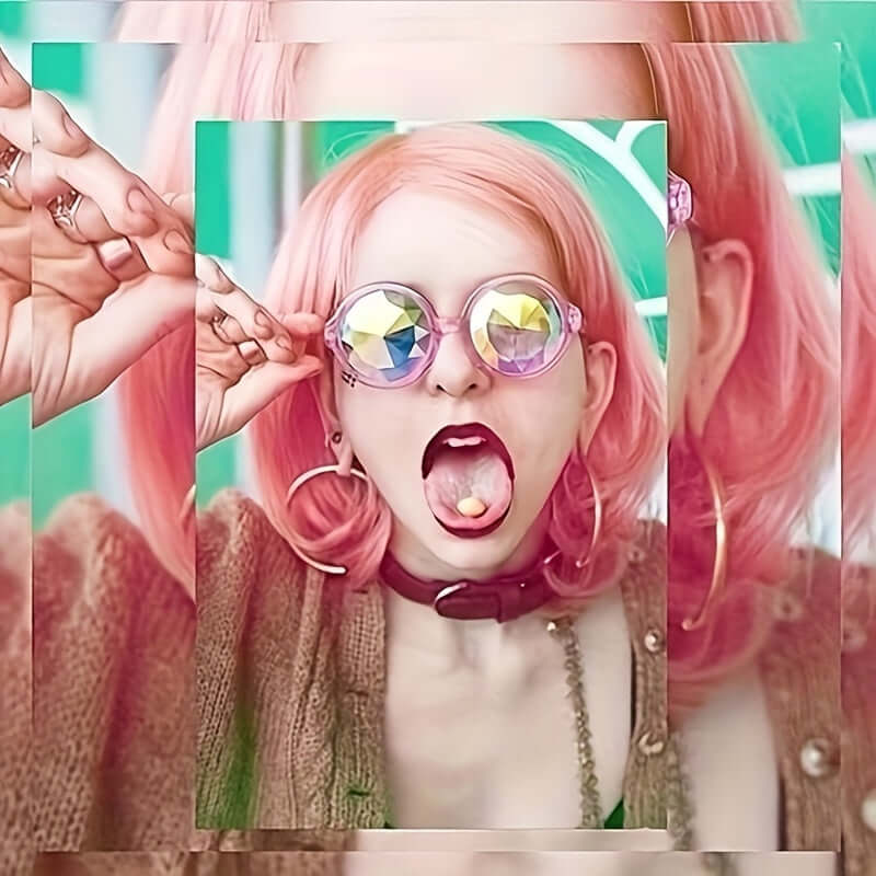 Person wearing kaleidoscope prism glasses with gradient lenses and pink hair, in a vibrant rave style fashion.