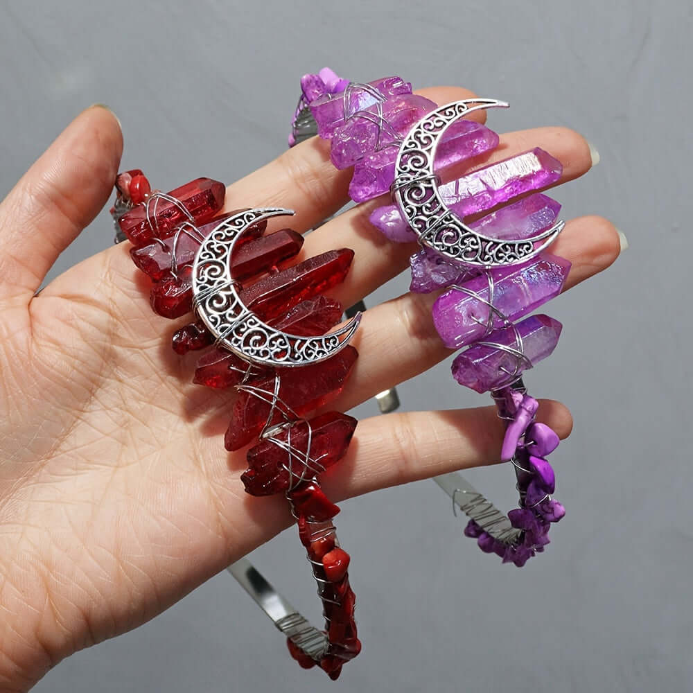 Hand holding red and purple natural crystal headbands with moon-shaped accents, ideal for boho-chic weddings and special occasions.