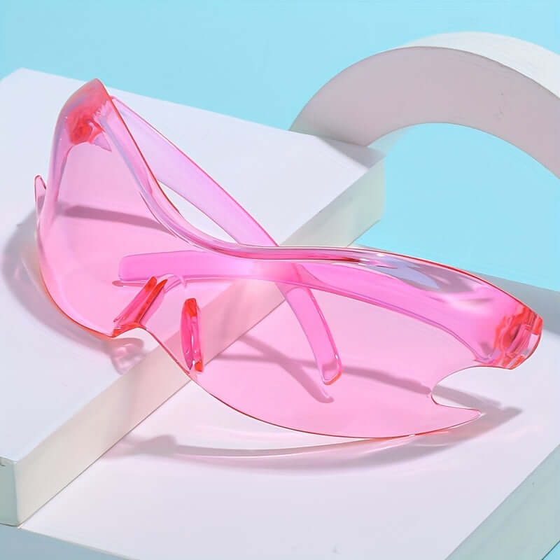 Stylish pink oversized Y2K rave sunglasses with gradient lenses and durable frame on display.