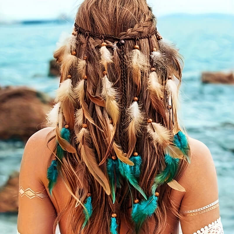 Woman wearing bohemian feather headband with faux feathers, standing by the sea.